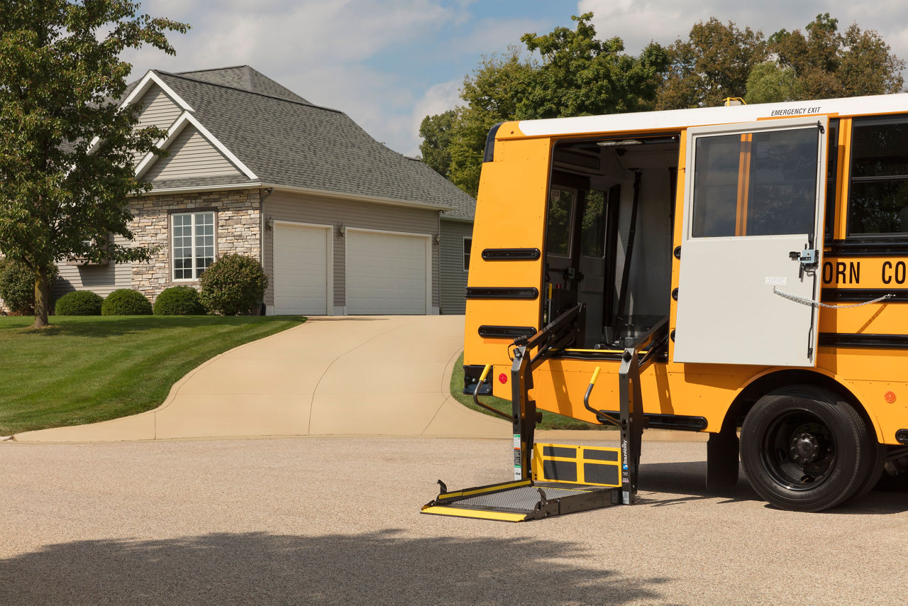 Wheelchair accessible school bus with lift deployed, used for special needs and disability student transportation