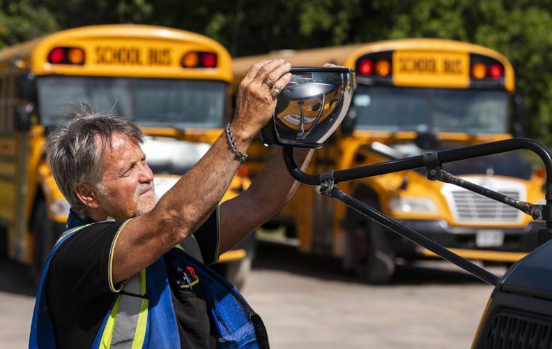 Guardian driver performing a safety inspection on a bus