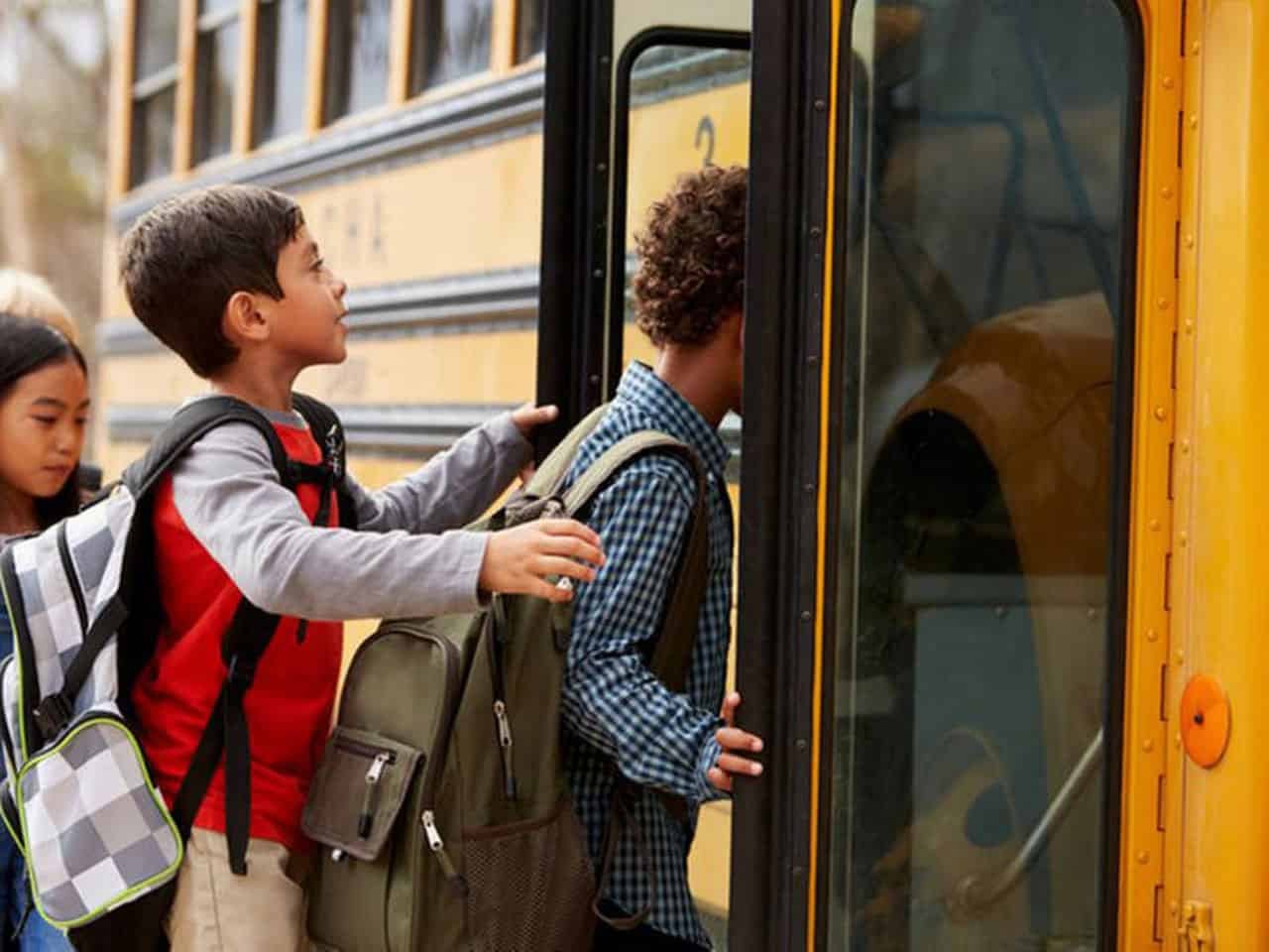 Students boarding a Guardian Bus Lines school bus for home-to-school transportation